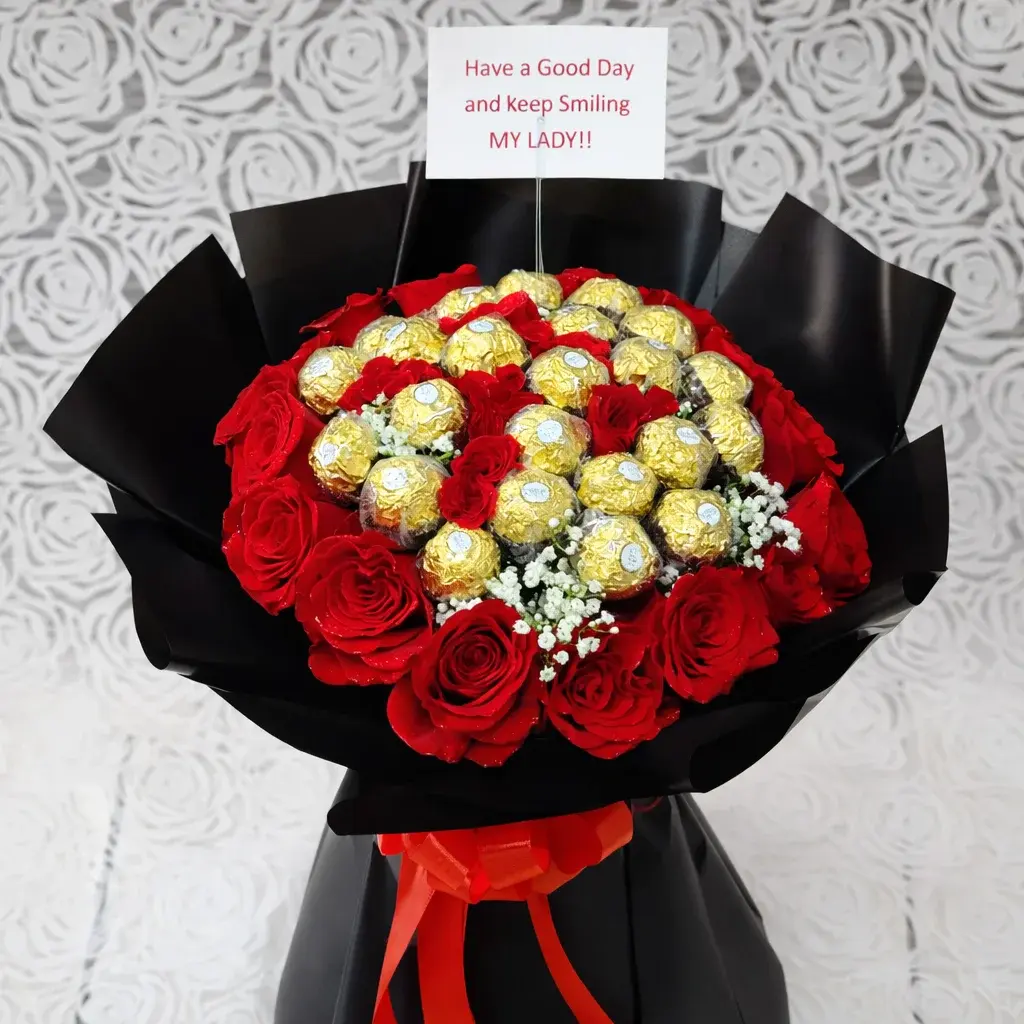red roses and ferrero hand bouquet